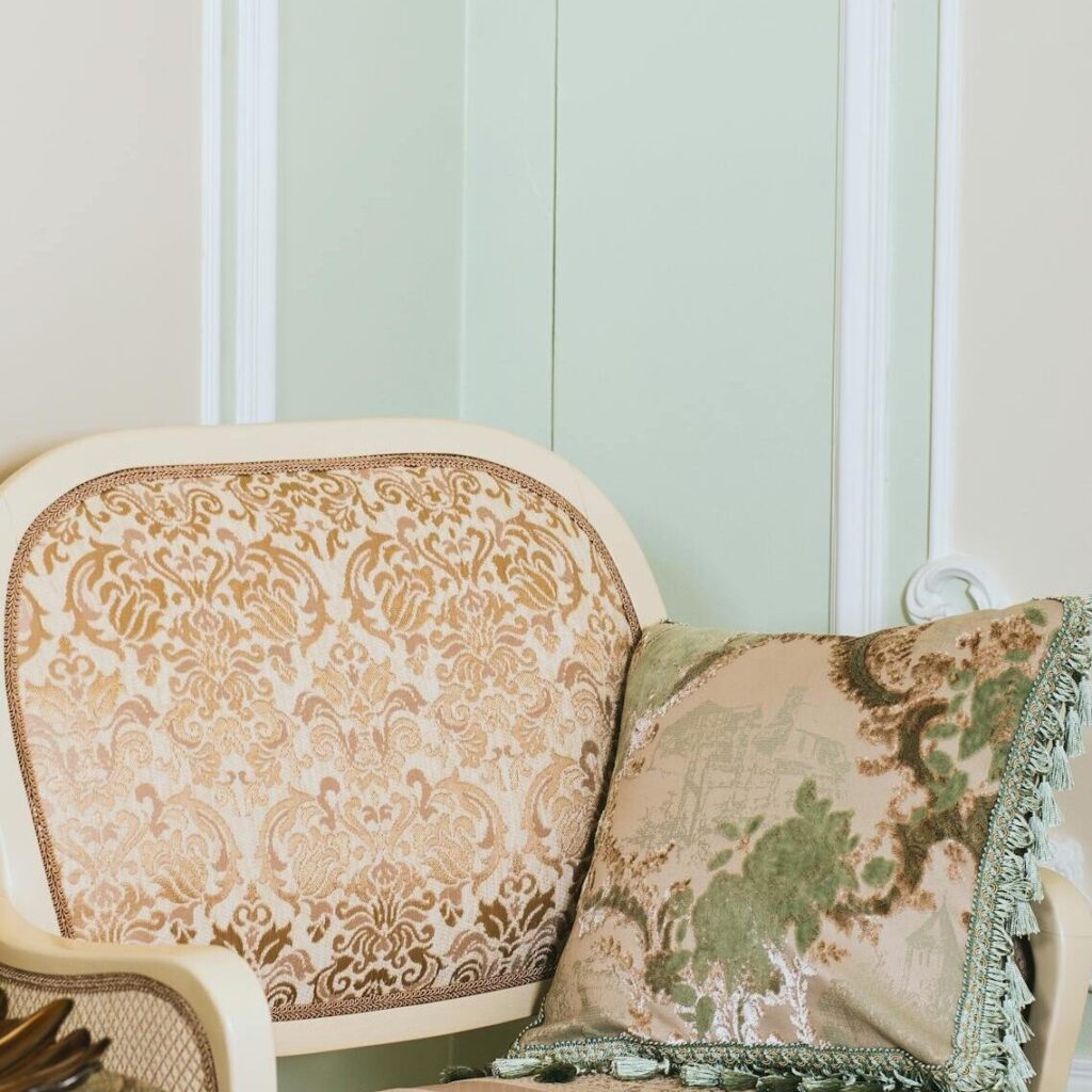 Elegant armchair and decor in a detailed interior setting with soft lighting.