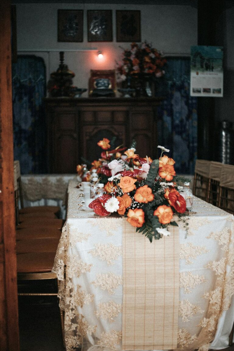 Vintage dining room with ornate table setup and lush floral centerpiece creating a luxurious ambiance.